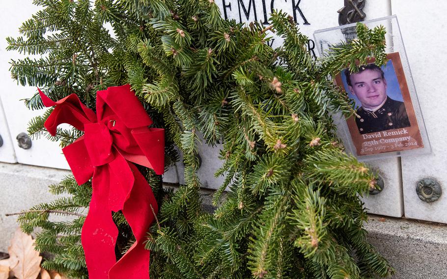 Volunteers place wreaths at the US Naval Academy Cemetery Stars and